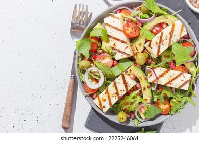 Salad with fried Halloumi cheese, cherry tomatoes, arugula and pomegranate seeds. healthy food. copy space - Shutterstock ID 2225246061
