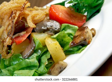 Salad with fried onions, potatoes and mushrooms
