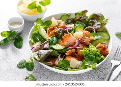 Salad with grilled salmon, fresh green salad leaves, cucumber, red onion, mint and pineapple. Healthy lunch salad for keto diet - Powered by Shutterstock