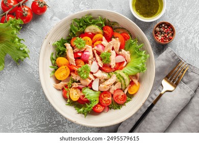 Salad with grilled salmon, fresh green  leaves, cucumber, tomatoes, sweet pepper and radish. Healthy lunch salad in bowl. - Powered by Shutterstock