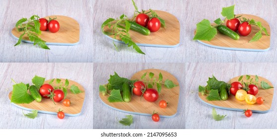 Salad ingredients (cherry tomatoes, cucumbers, gherkins, greens) on a wooden cutting board on a light background