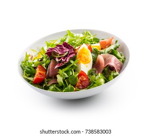 Salad Isolated on White. a bowl of fresh lettuce salad with tomatoes eggs prosciutto over white. - Shutterstock ID 738583003