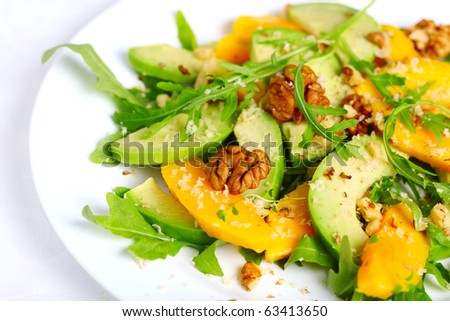Salad with mango, avocado, arugula and walnuts