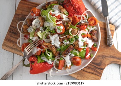 Salad With Meat, Roasted Vegetables And Yogurt Dressing. Served On Plate On White Wooden Table. Overhead View