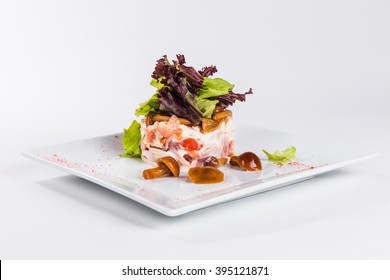 Salad With Mushrooms On A Square Plate On A White Background