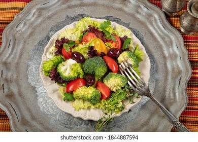 Salad With Olives On An Old Metal Desk