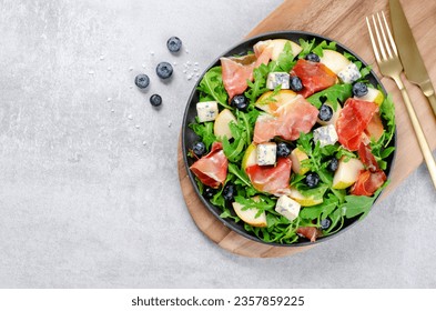 Salad with Pear, Arugula, Jamon, Blue Cheese and Blueberry, Delicious Fresh Salad Appetizer on Bright Background