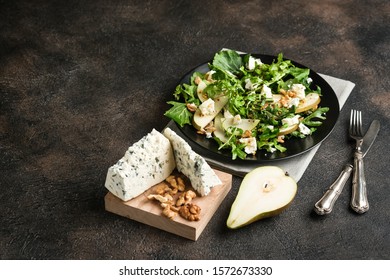 Salad Of Pear, Blue Cheese, Arugula And Nuts With Spicy Dressing On A Dark Background Free Copy Space. Healthy Eating