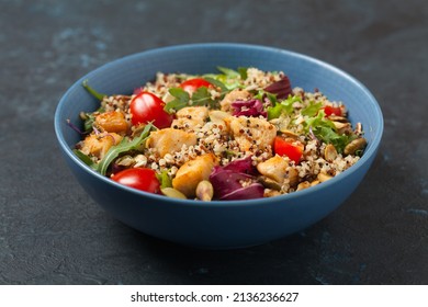 Salad With Quinoa, Avocado And Chicken. Front View. Served In A Blue Bowl.