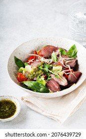 Salad With Roast Beef And Oyster Mushrooms, Herbs, Cherry, Basil And Pesto Sauce, Gray Background
