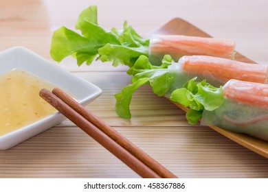 Salad roll crabvegetables and crab stick with salad seafood dressing in wooden plate - Shutterstock ID 458367886