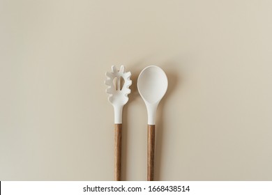 Salad Serving Utensils Set. Spoon And Fork On Beige Background. Minimal Kitchenware Concept.