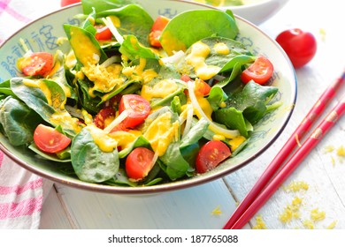 Salad With Spinach, Onions, Tomatoes And A Yellow Turmeric Dressing