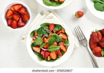 Salad with strawberry, red onion and spinach in white bowl. Healthy breakfast. Top view, flat lay - Powered by Shutterstock