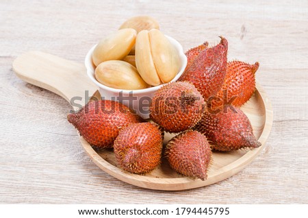 Salak Palm , waive or snake fruit on wooden background.