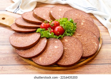 Salami Plate On Wood Floor. Close Up