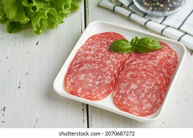 salami sausage on white plate white background