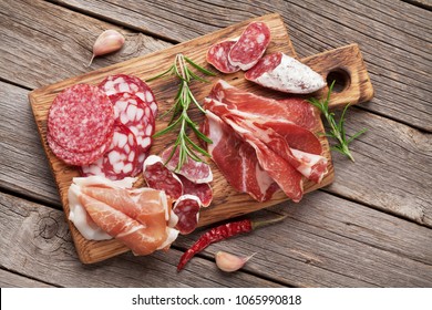 Salami, Sliced Ham, Sausage, Prosciutto, Bacon. Meat Antipasto Platter On Wooden Table. Top View