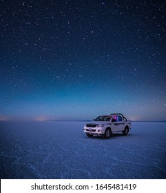 SALAR DE UYUNI / BOLIVIA APRIL 05, 2018: Off Road Car Stays On The Uyuni Salt Flat During Starry Night