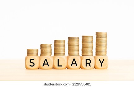 Salary Raise Concept. Wooden Blocks With Text And Rising Stacked Coins. Copy Space