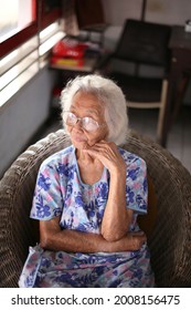 Salatiga Indonesia-october 15 2010: Old Chinese Lady Sitting In Old Chair Seing View Offside. Retiremen,grandmother