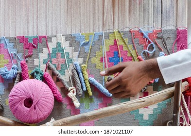 Salawas village, Rajasthan, India - 10.12.2016: Colorful threads on a loom for traditional Panja dhurrie weaving with motion blur