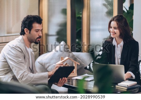 Sale agent estate working  to customer at office 