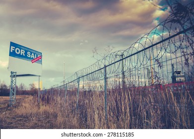 A For Sale Billboard Sign In An Urban Industrial Wasteland Or Vacant Lot