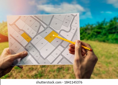 sale of building plot of land for house construction. cadastral map on field background - Shutterstock ID 1841145376
