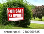 For Sale By Owner sign in a yard - Real estate housing market economy