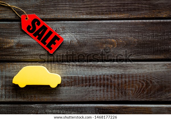 Sale for cars in shop with lable on wooden desk
background top view mock
up