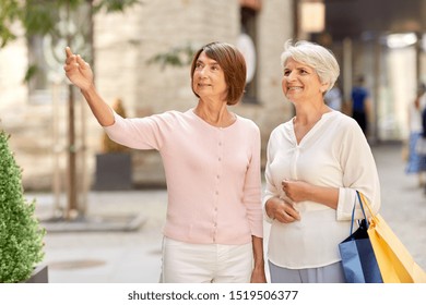 Sale, Consumerism And People Concept - Two Senior Women Or Friends With Shopping Bags On Tallinn City Street