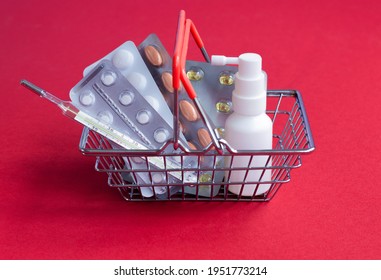 Sale And Discount. Biggest Medicines Store. Shopping Basket With Tablets Pills Close Up. Medical Supplies. Essential Medicines For Home Treatment. Medicines Red Background Copy Space Red Back