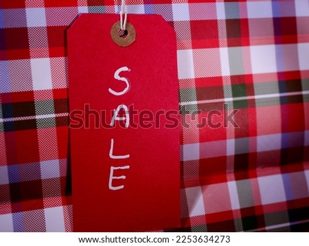 Sale gift bag on check background close up shot selective focus