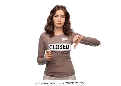 Sale, Lockdown And Business Concept - Female Shop Assistant With Closed Sign And Name Tag Showing Thumbs Down Over White Background