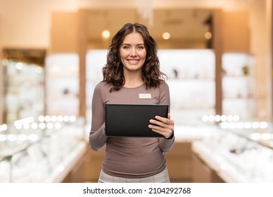 Sale, Shopping And Business Concept - Happy Female Shop Assistant With Tablet Pc Computer Name Tag Over Jewelry Store Background