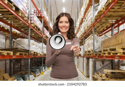 sale, shopping and business concept - happy female worker or storekeeper with megaphone and name tag over warehouse background - Shutterstock ID 2104292783