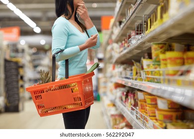 sale, shopping, consumerism and people concept - woman with food basket at grocery store or supermarket - Shutterstock ID 562292047