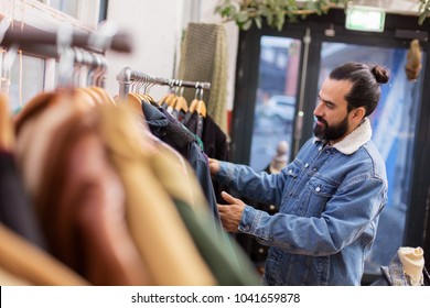 Sale, Shopping, Fashion And People Concept - Man Choosing Clothes At Vintage Clothing Store