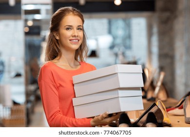 Sale, Shopping And People Concept - Happy Young Woman Or Shop Assistant With Shoe Boxes At Store