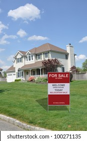 For Sale Sign On Suburban Home Front Yard Lawn