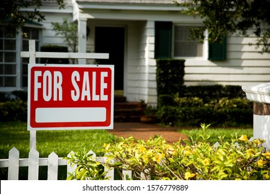 For sale sign outside a family house - Shutterstock ID 1576779889