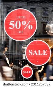 Sale signs in shop window, big reductions - Shutterstock ID 2311257539
