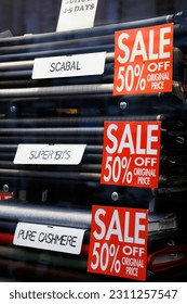 Sale signs in shop window, big reductions - Shutterstock ID 2311257547