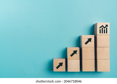 Sale volume increase make business grow , Business growth concept , wood block stacking as step stair on paper blue background, copy space.