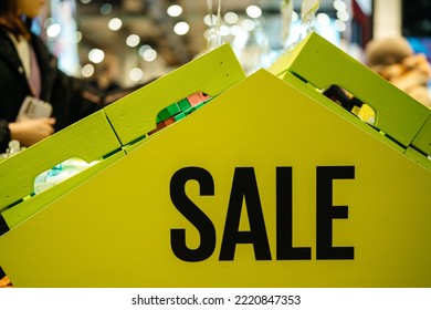 Sale, word on green bright acid banner in huge store. Seasonal and holiday discount promotion. - Powered by Shutterstock