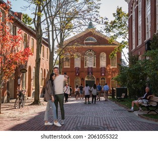 Salem, MA, US-October 14, 2021: Tourists pose for selfie photographs during the annual Haunted Happenings event held in October in celebration of the town's history of witch trials and of Halloween. 