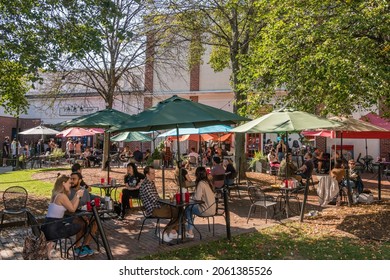 Salem, MA, US-October 14, 2021: People eat at outdoor restaurant at the annual Haunted Happenings event held in October in celebration of the town's history of witch trials and of Halloween. 