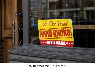 Salem, OR, USA - Mar 31, 2022: Now Hiring Sign Is Seen At The Storefront Of A Local Business In Salem, Oregon, As Labor Shortage Persists Across The Nation.