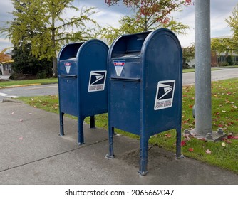 Salem, Oregon USA - September 19, 2021: An angular view of United States postal service collection mail boxes on the sidewalk along roadside